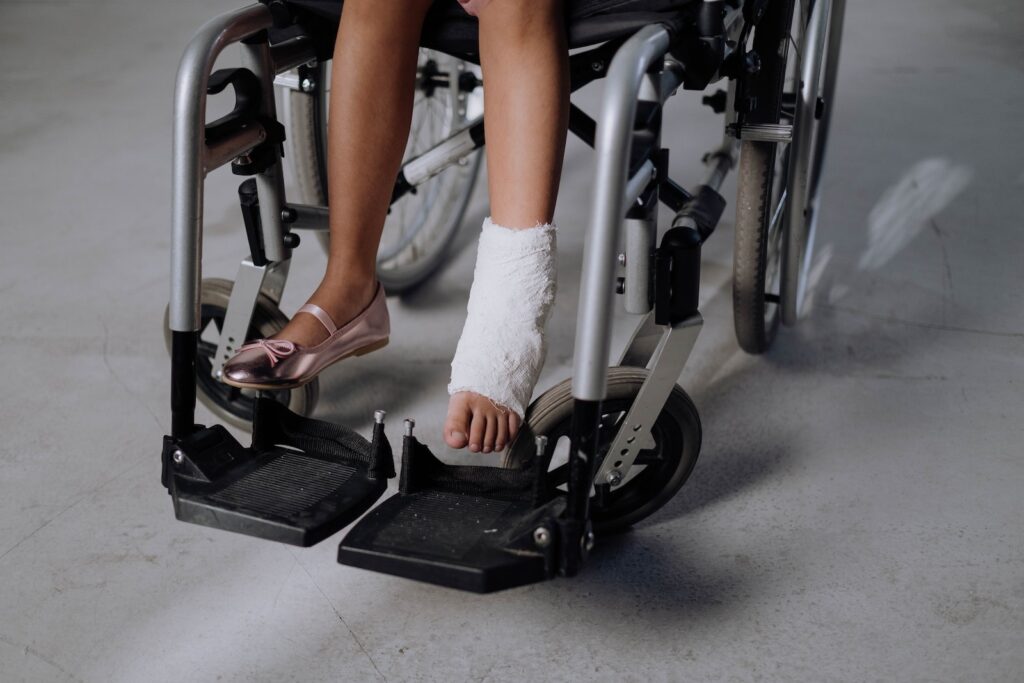 A Girl with Orthopedic Cast Sitting on a Wheelchair